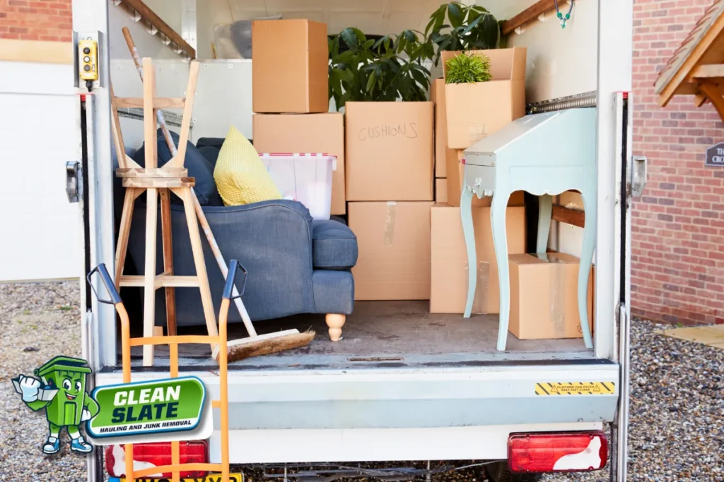 Truck loaded with furniture and boxes comparing DIY disposal and professional junk removal
